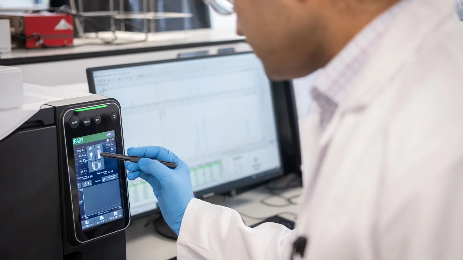 UKRI Interdisciplinary Centre for Circular Chemical Economy team member in a lab coat using a touch screen device for their work